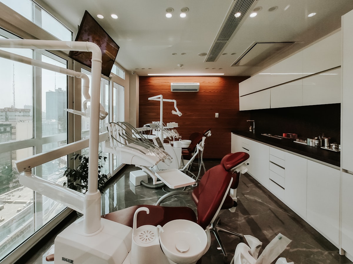 Two dental chairs in a daylit surgery