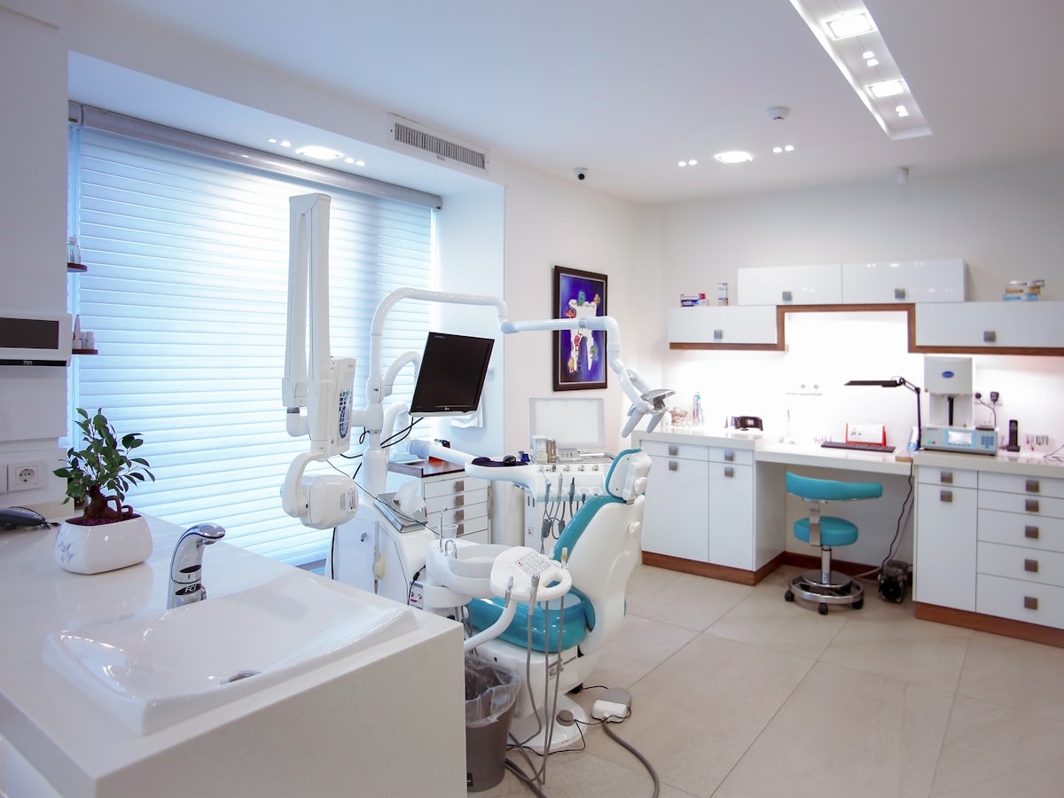 A bright dental treatment room with the chair and worktop laid out